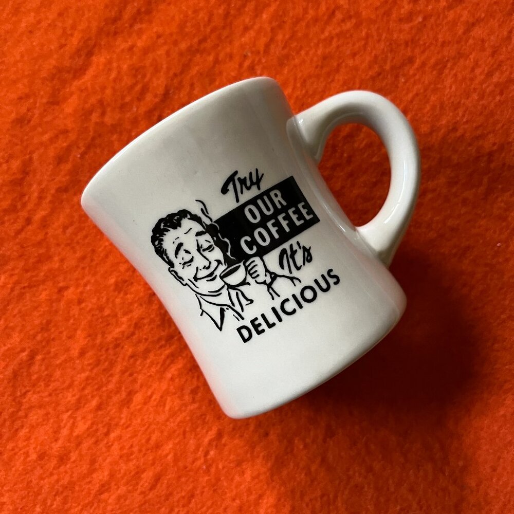 Ceramic "Try Our Coffee It's Delicious" mug (no brand)